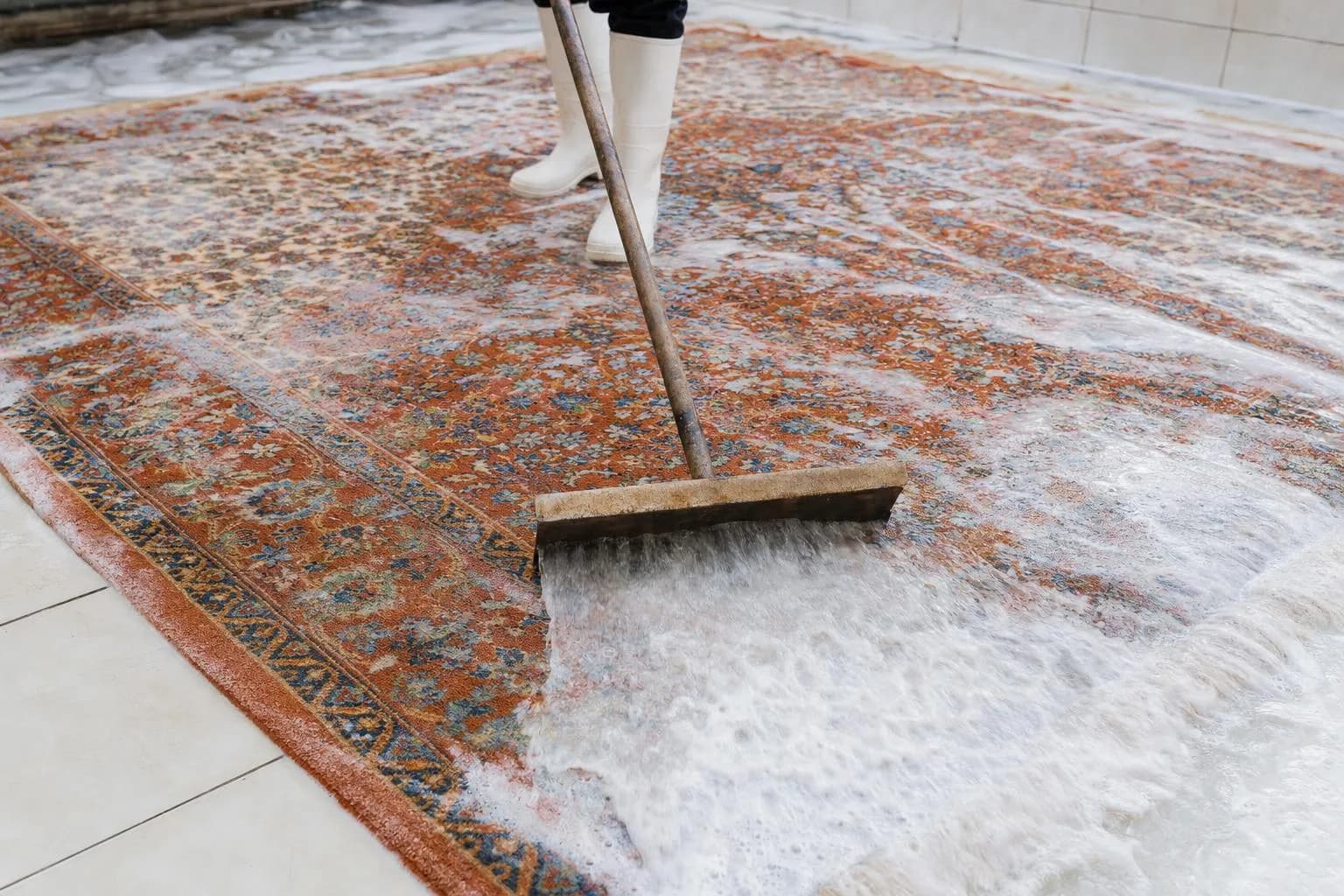 Teppich-Geruchsentfernung: Tiefenwäsche eines Wollteppichs mit klarem Wasser in der Teppichwäscherei Hamburg